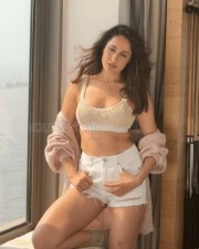 Stylish and Sexy Pragya Jaiswal in a Pink Sweater White Top and Mini Shorts Photos 03