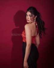 Telugu Actress Krithi Shetty in a Red Cutout Halter Neck Top and Black Skirt Pictures 05