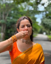 Beautiful Ashika Ranganath in a Vibrant Orange Saree with a Sleeveless Blouse Photos 04