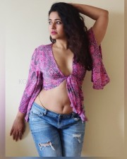 Enchanting Poonam Bajwa in a Knotted Pink Top with Torn Jeans Photos 02