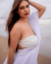 Bold Neha Malik in a White Saree with Sleeveless Blouse on the Beach Photos 01