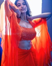 Gorgeous Meenakshi Chaudhary in a Striking Orange Dress Photos 03