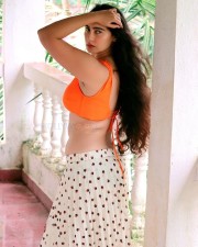 Desi Beauty Megha Shukla in a Printed Skirt and Orange Bralette Photos 06