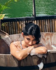 Provocative Kanika Mann in a Bathtub wearing a Blue Strapless Swimsuit Pictures 04