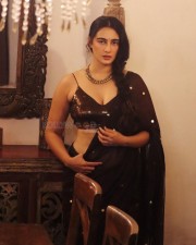 Sexy Damsel Megha Shukla in a Black Saree with a Shimmery Sleeveless Blouse Pictures 03